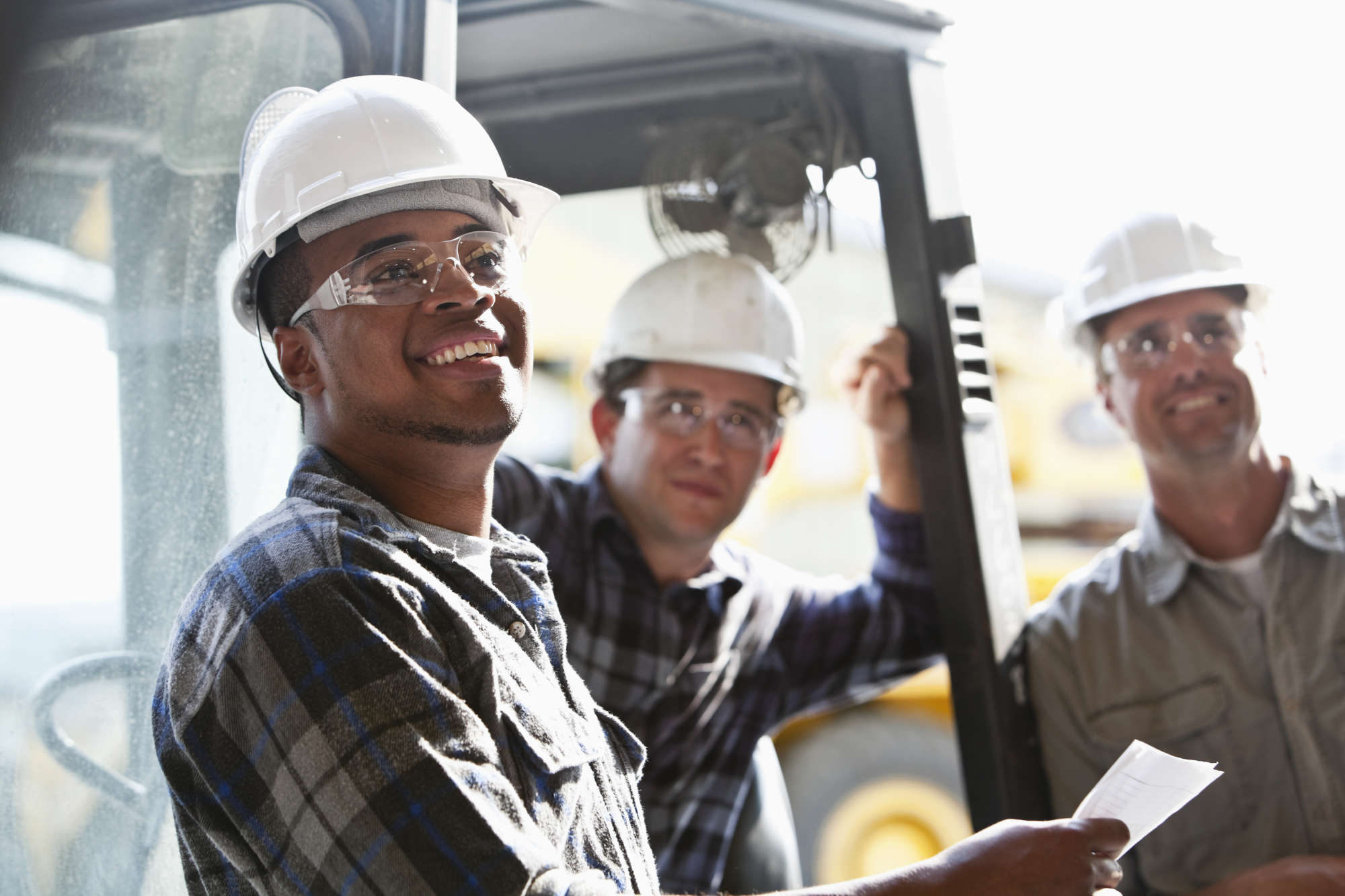 woman working on construction site yellow hard hat