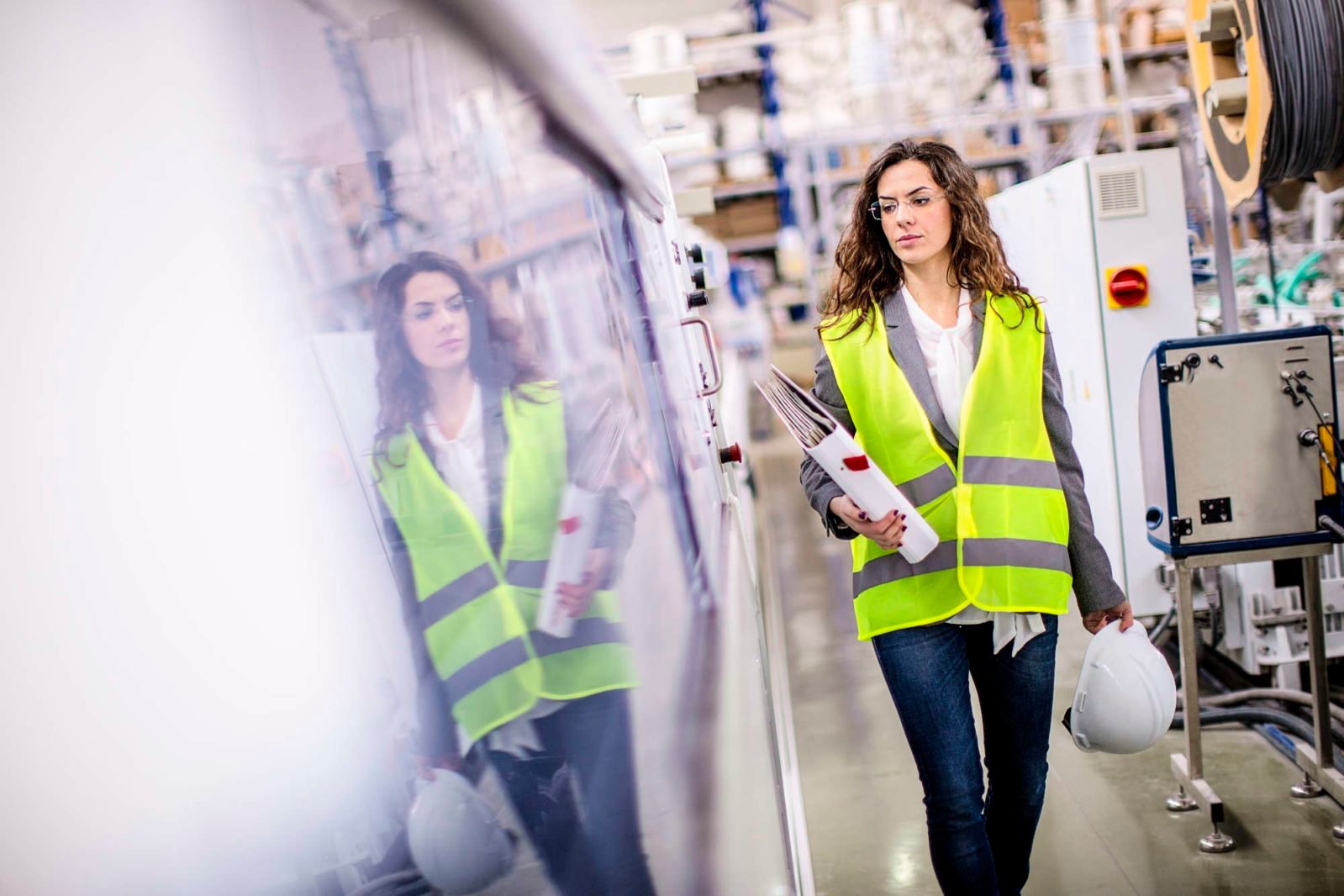 Young female worker walking through the factory