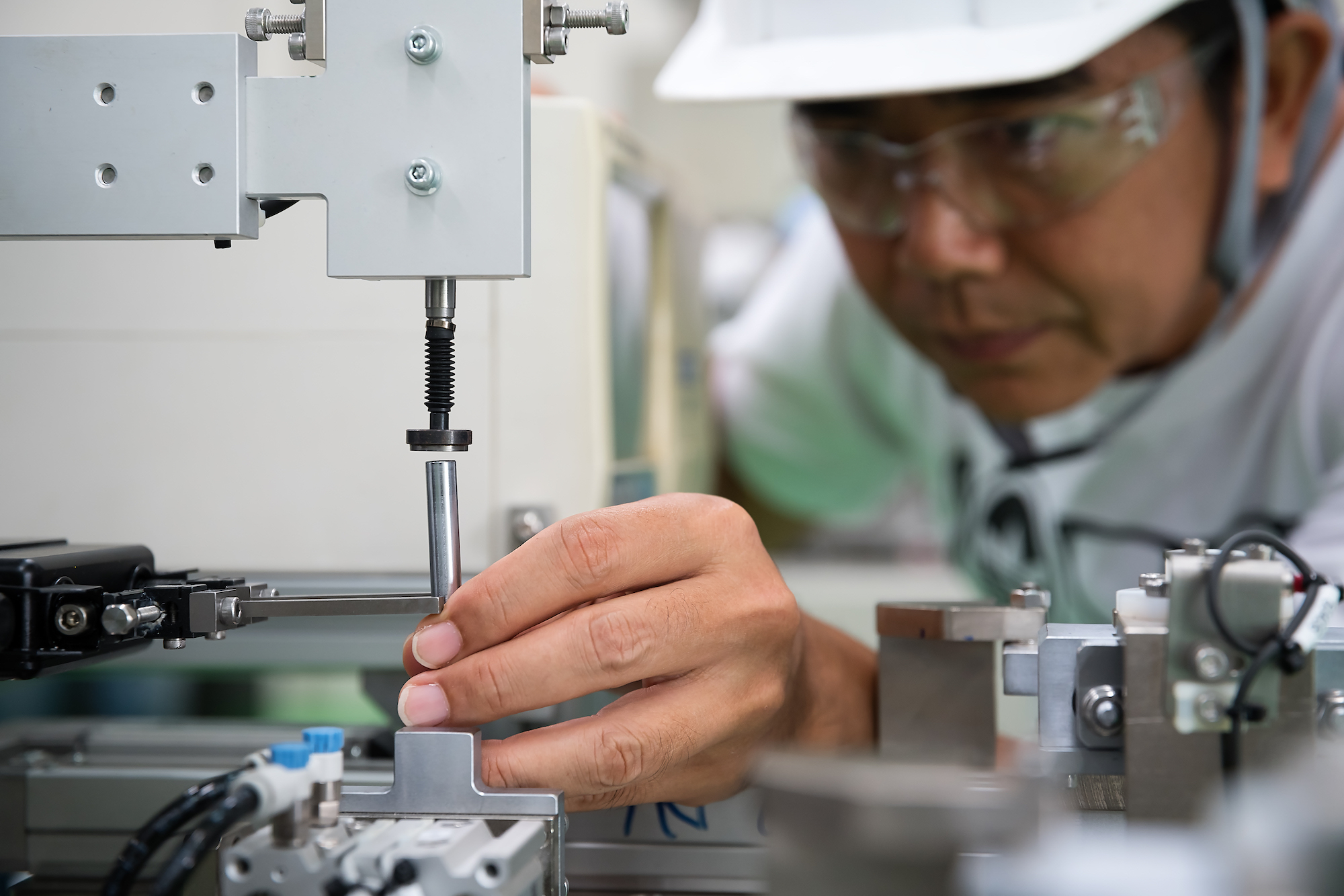 CNC machinist working in factory