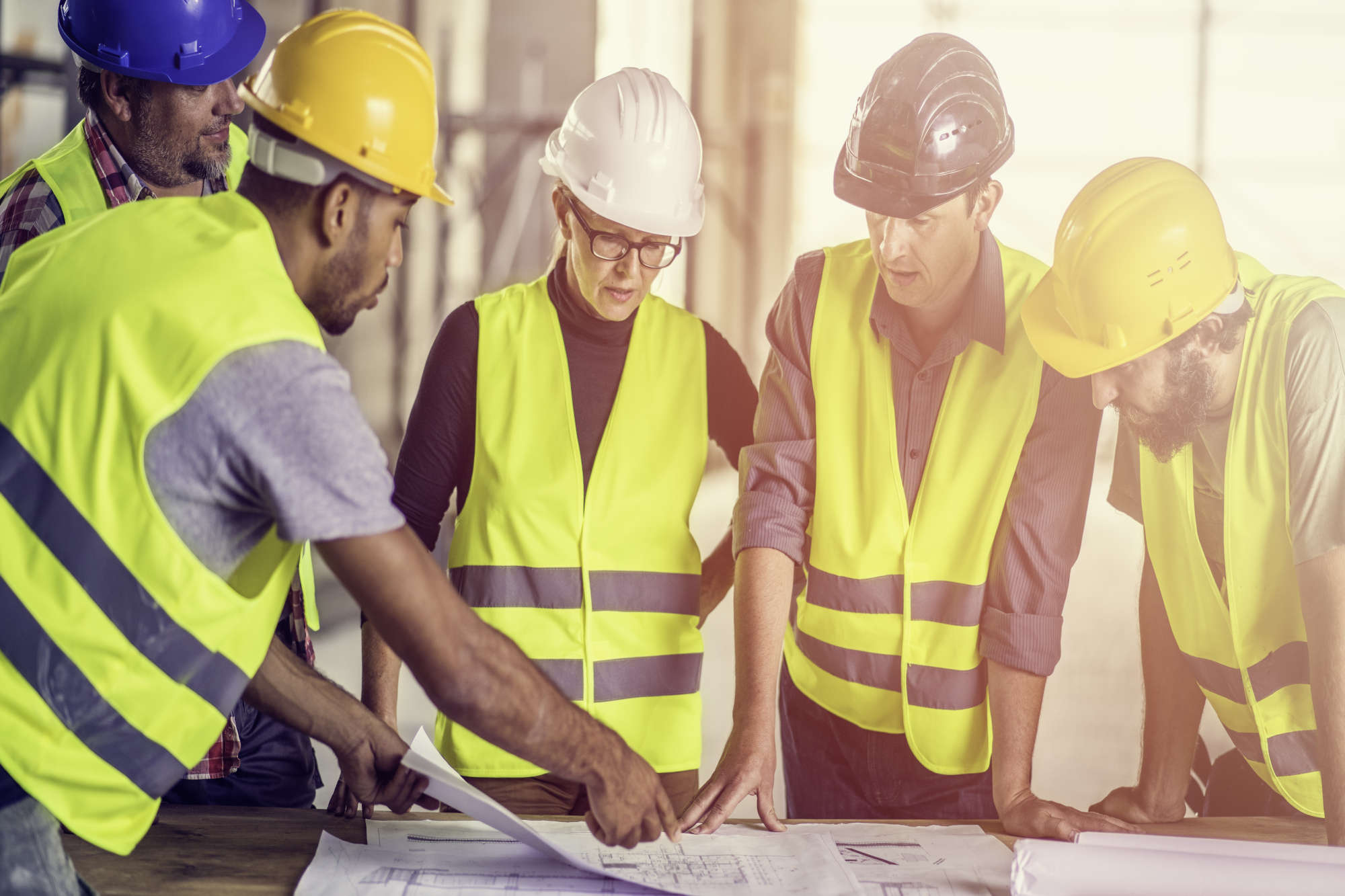 group of construction workers looking at plans