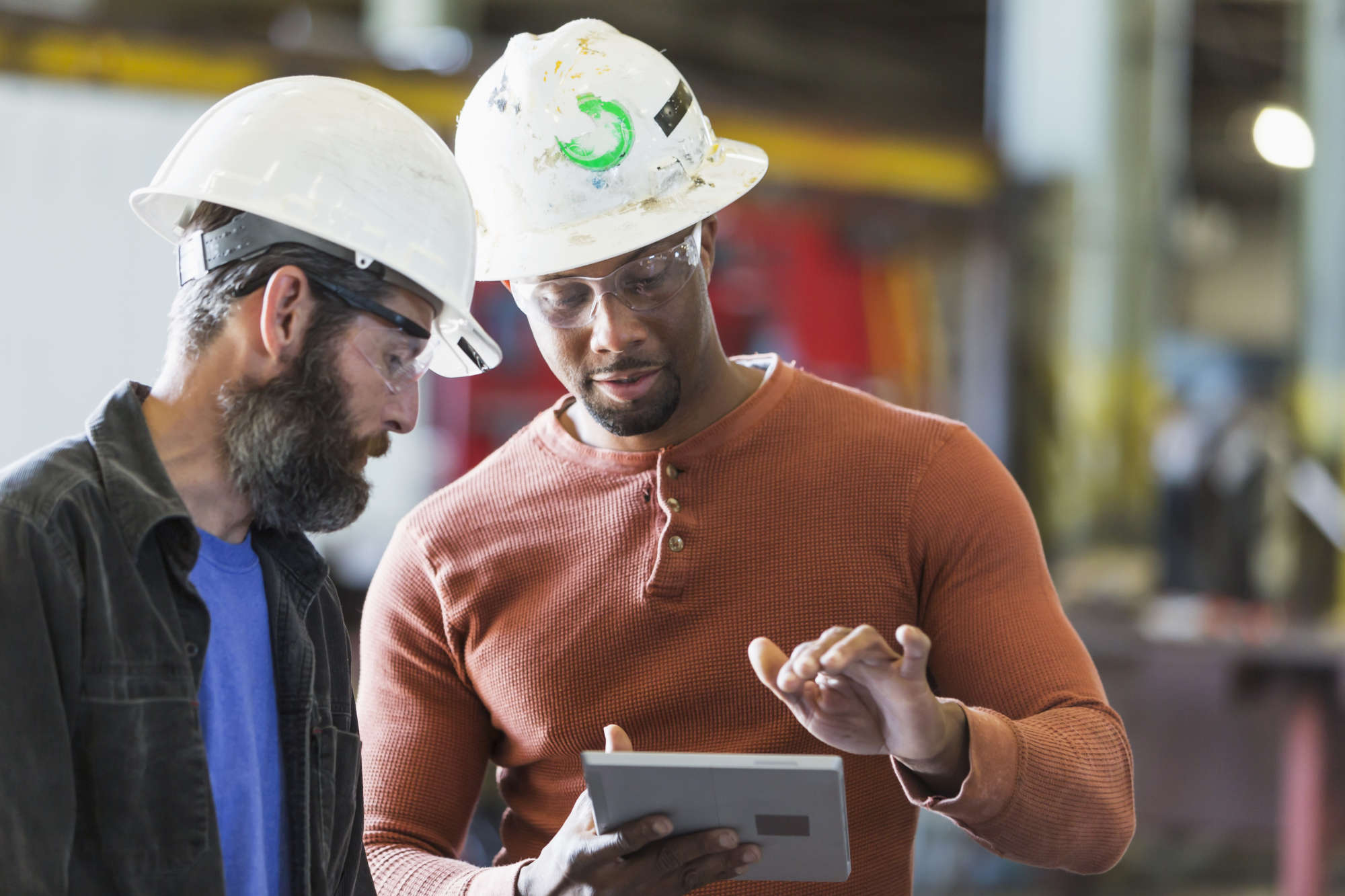 two tradesmen looking at plans